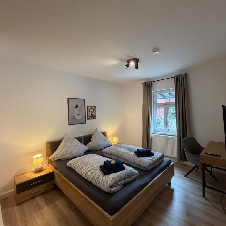 Moderne Küche mit Kochfeld, Kühlschrank und Essbereich bei Tageslicht.